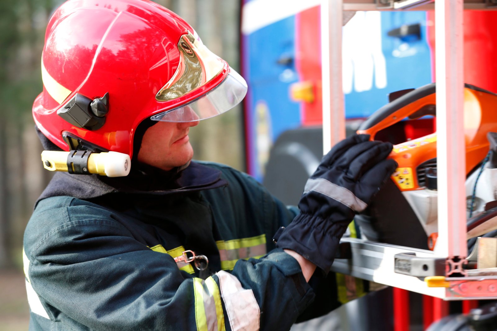 Firefighter retrieves fire hoses.The brave firefighter. Work of firefighter