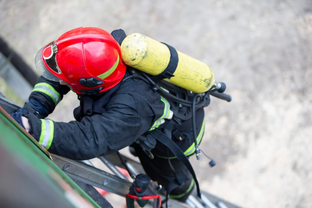 Firefighter climbs the stairs. Lifeguard training.